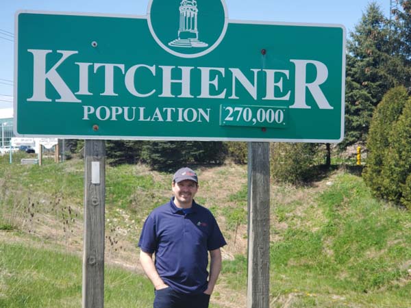 Owner Mike, standing next to Kitchener sign